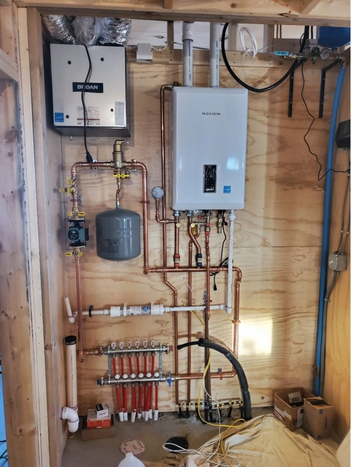 Wall-hung hydronic boiler installation with copper piping, expansion tank, circulator and radiant manifold